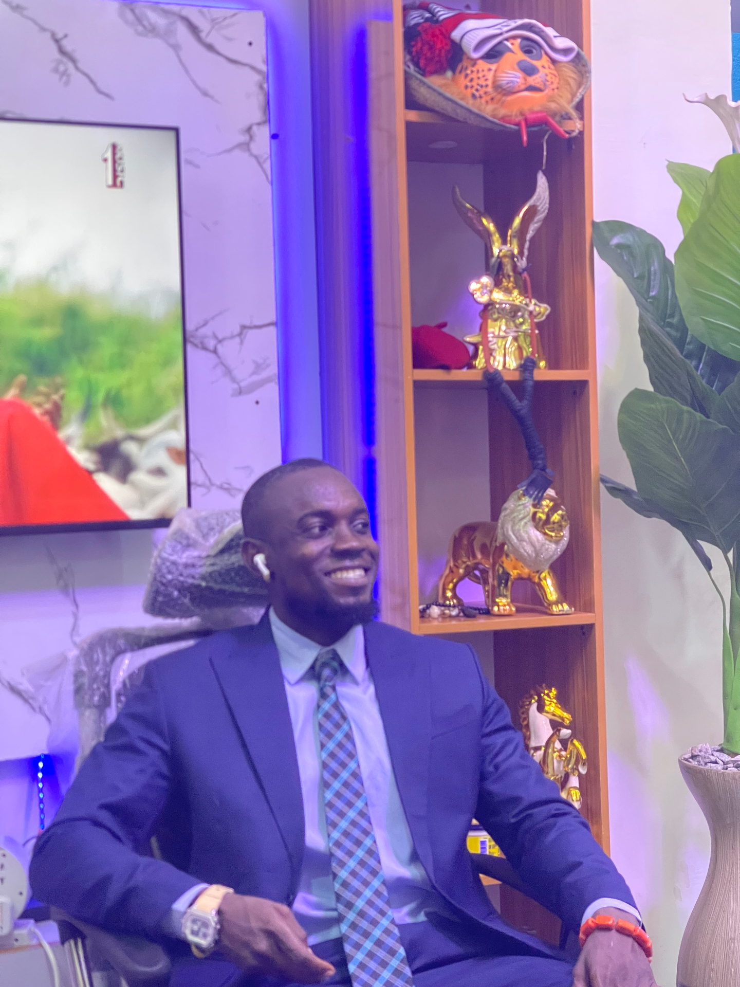 Founder of Solid Apt Wear in a tailored navy suit at the S.A.W. studio